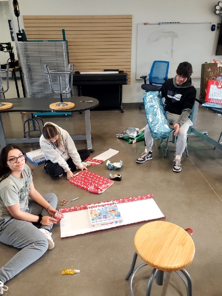 Students wrapping presents